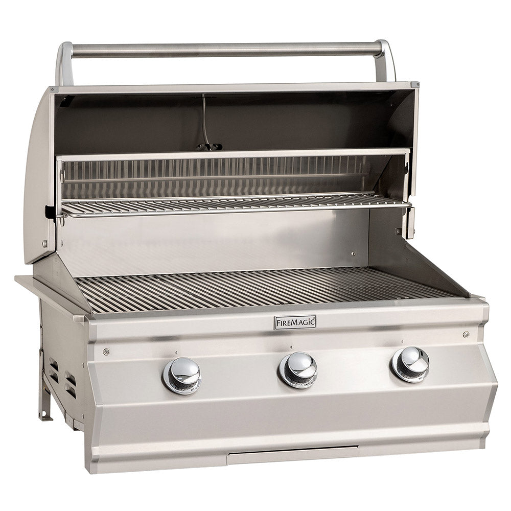 Open stainless gas grill with warming racks and grates inside, control knobs on front.