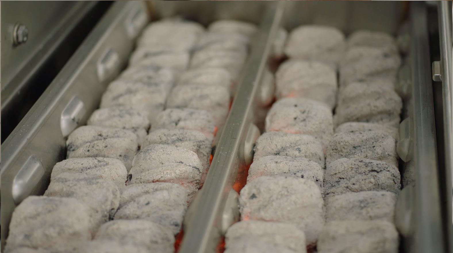 Charcoal tray filled with gray briquettes