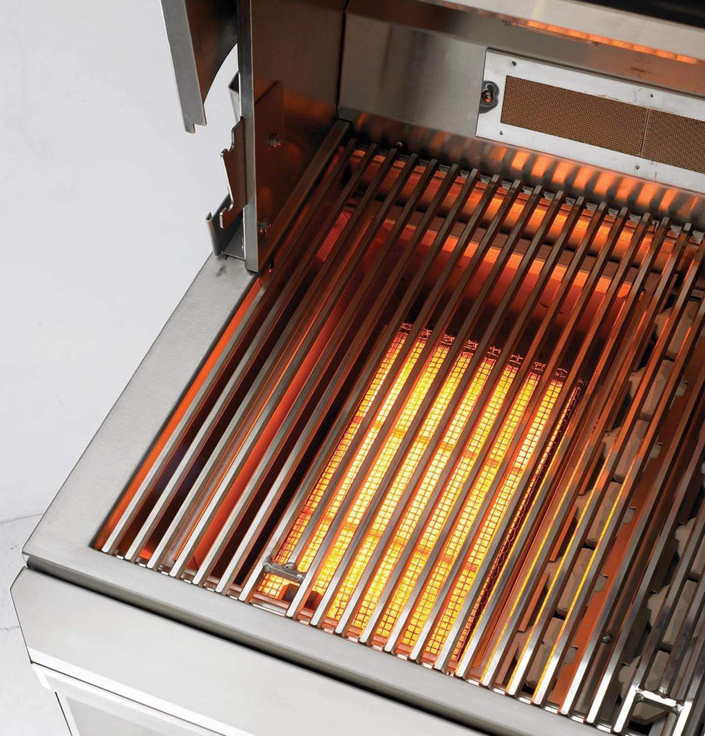 Gas grill radiant burner tubes glowing inside the open firebox
