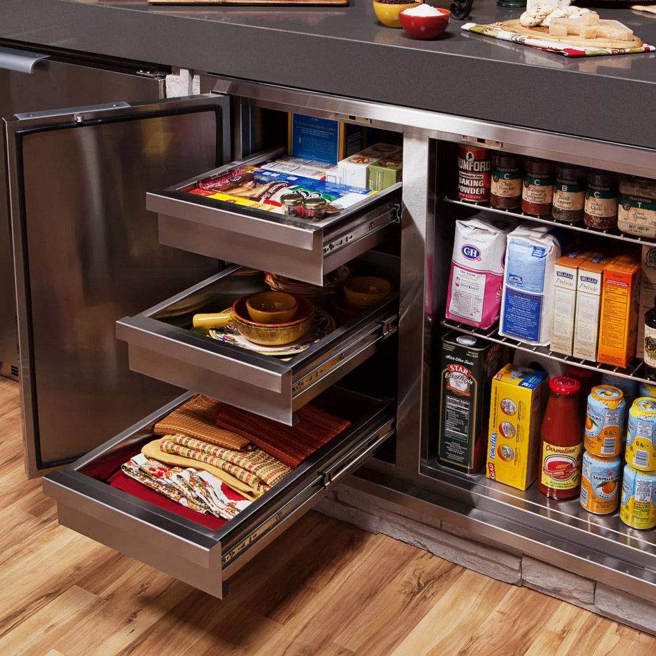 Dry storage pantry open with pull-out drawers holding pantry items