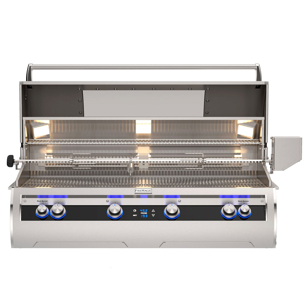 Built-in gas grill open hood showing stainless burners and blue control dials