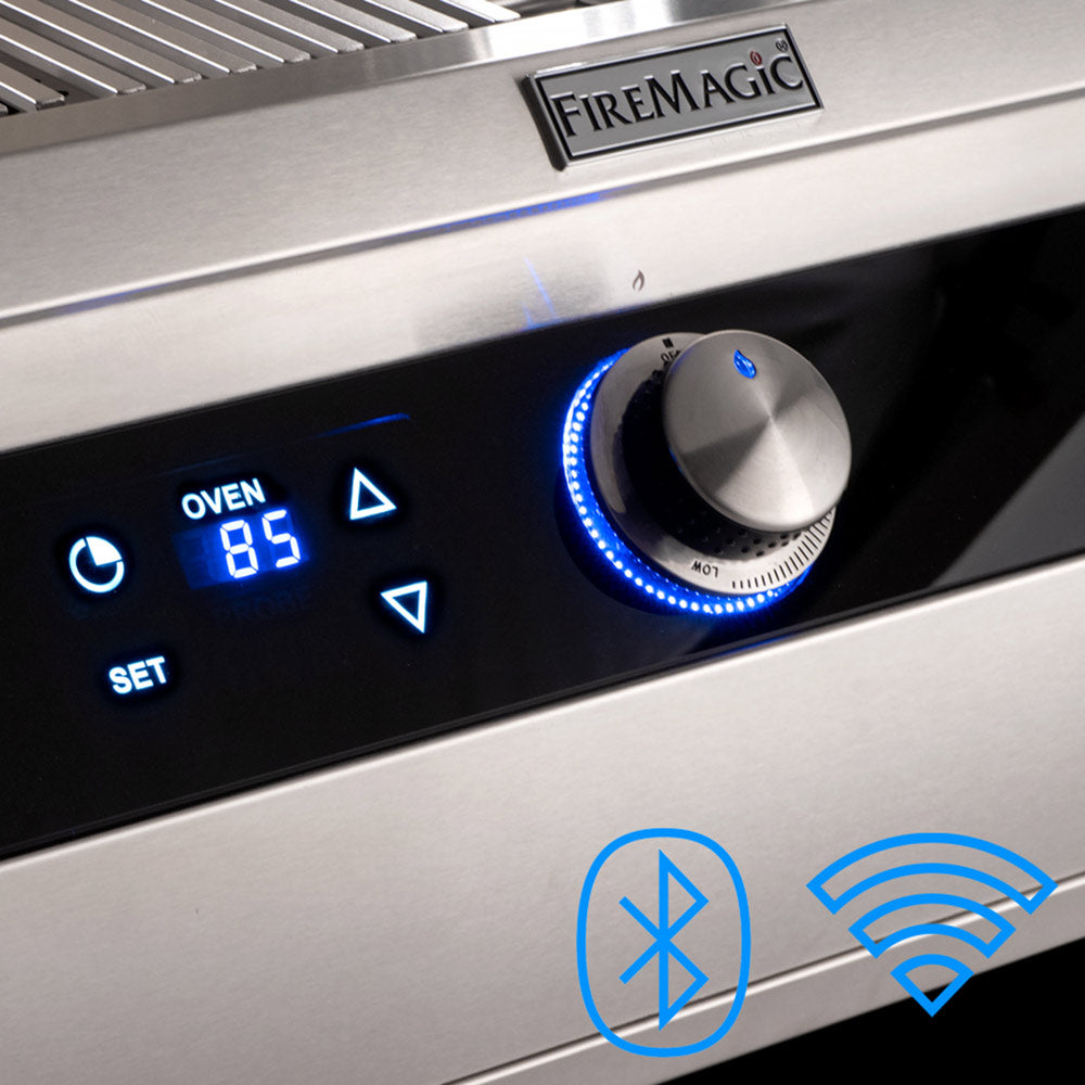 FireMagic grill control panel with blue-lit display, control knob, and oven settings