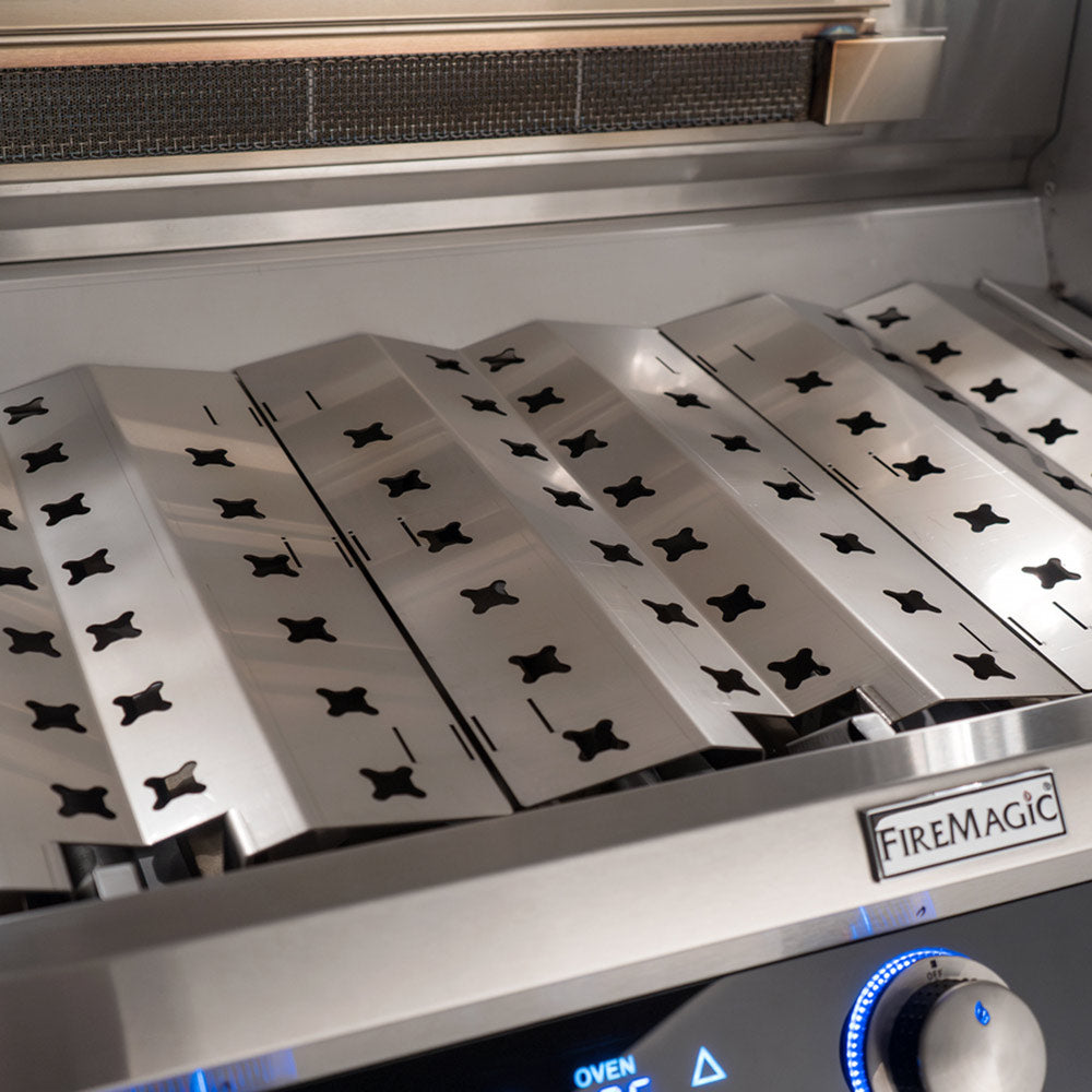 Open stainless grill with cooking grates and decorative patterned plates
