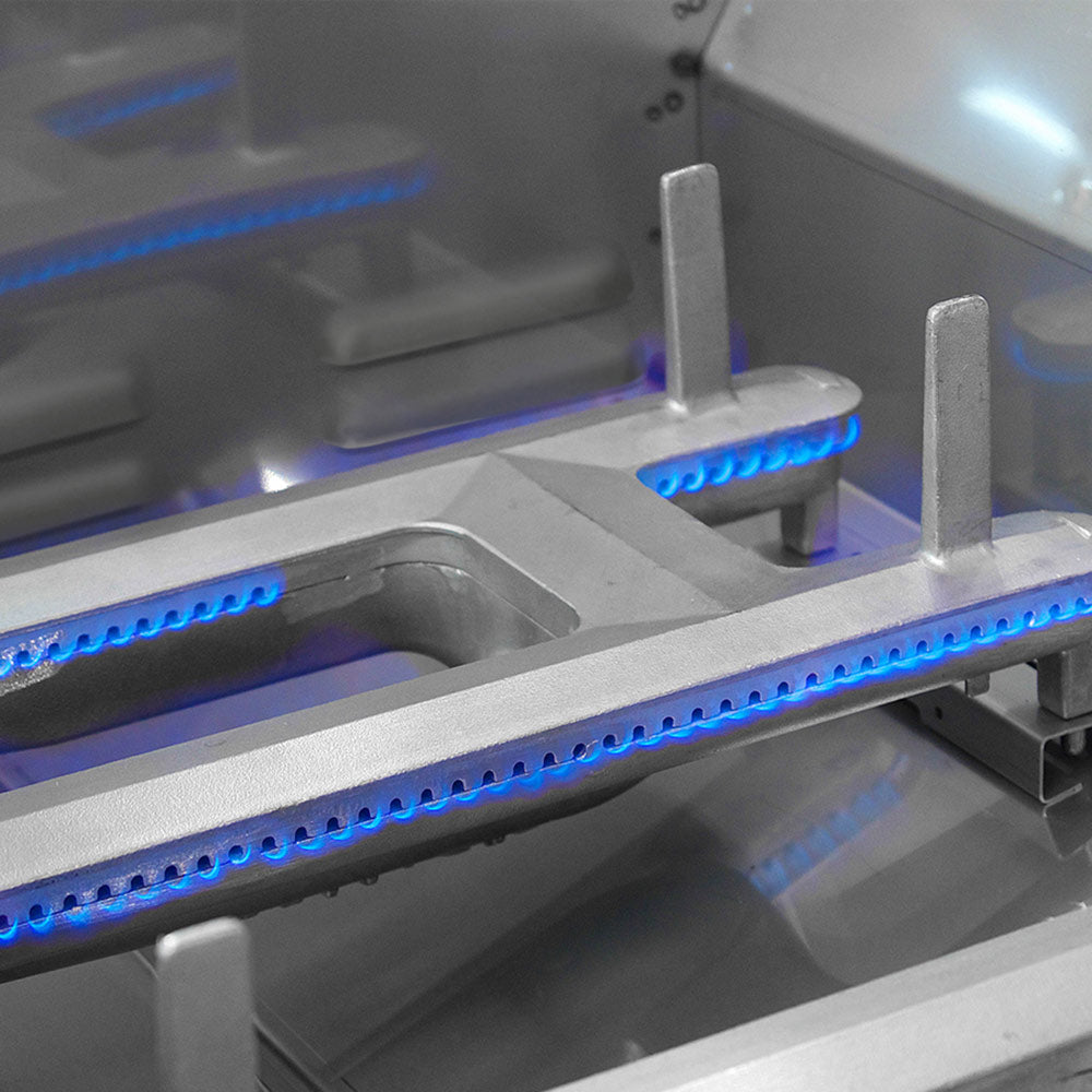 Fire Magic grill interior with blue LED burner lights and metal control area