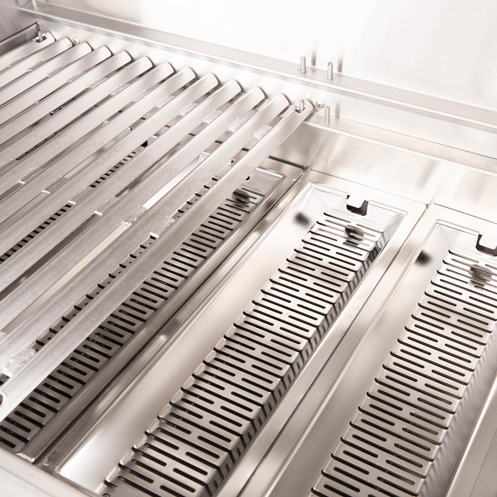 Stainless grill heat plates with burner rows inside a dual fuel grill.