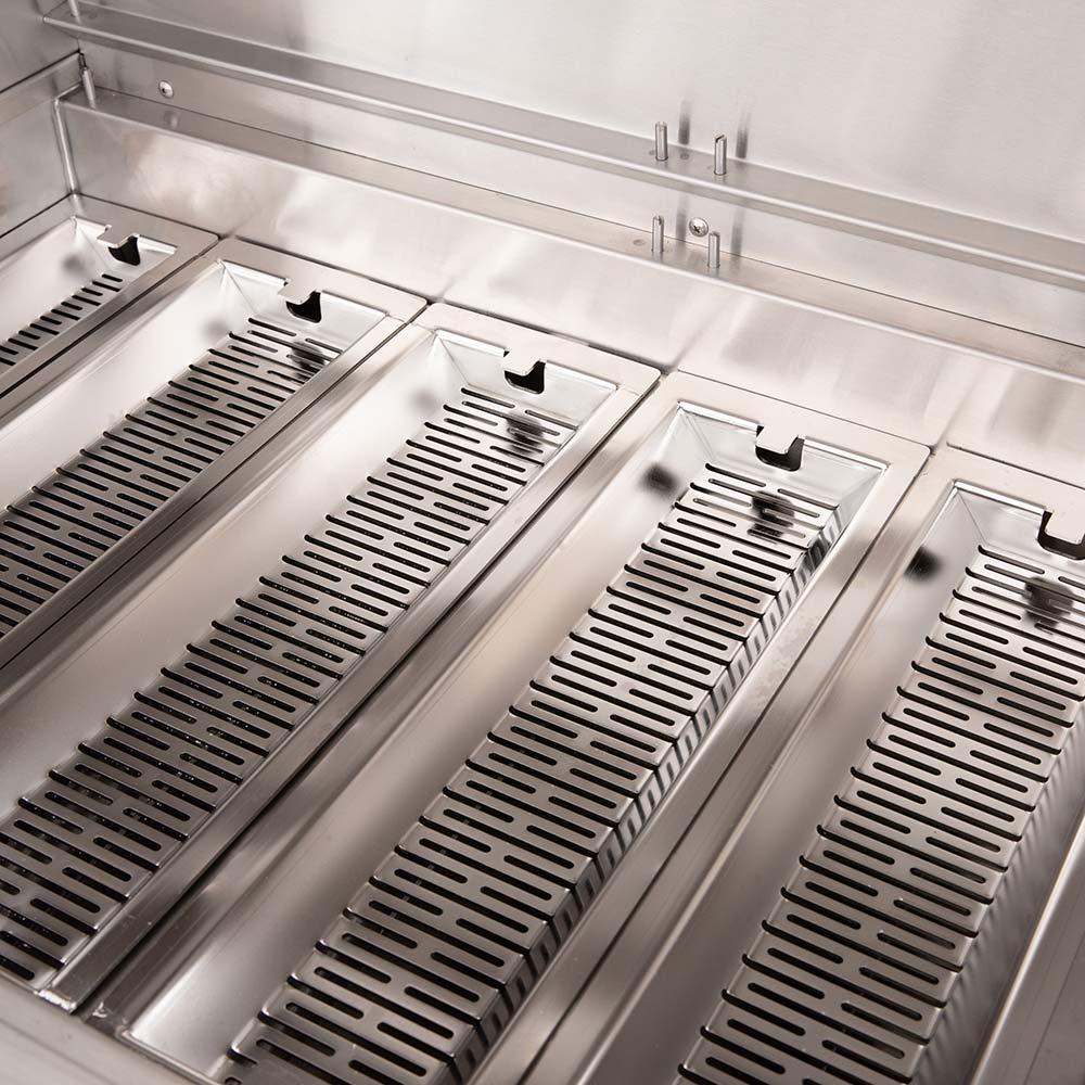 Close-up of stainless grill burners and heat plates inside a dual fuel grill.