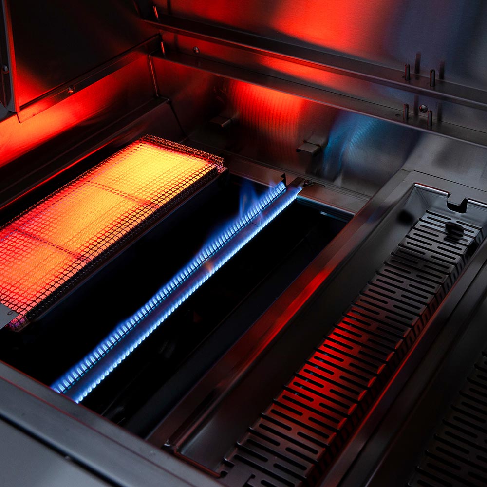 Built-in dual fuel grill interior with red and blue burner glow and stainless grates