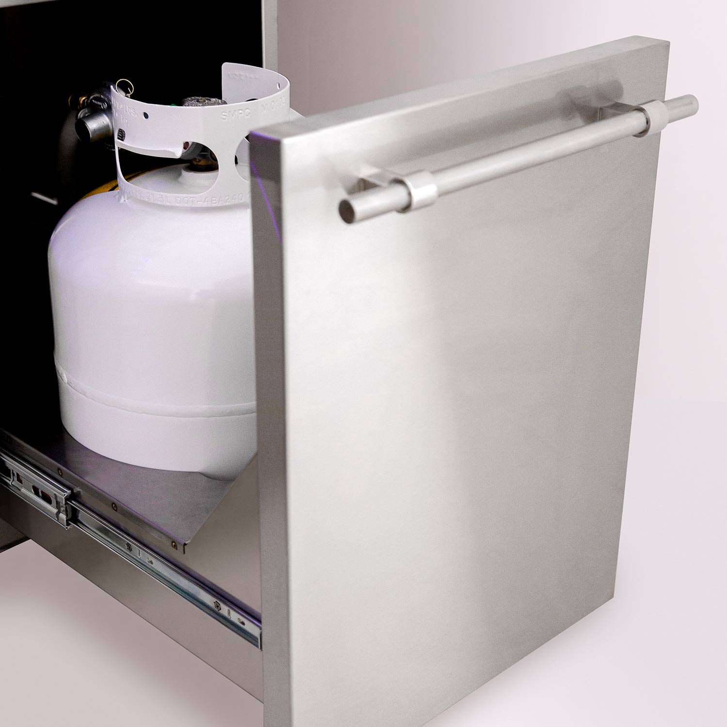 Gas cylinder storage compartment with control rail on a dual fuel grill cart.