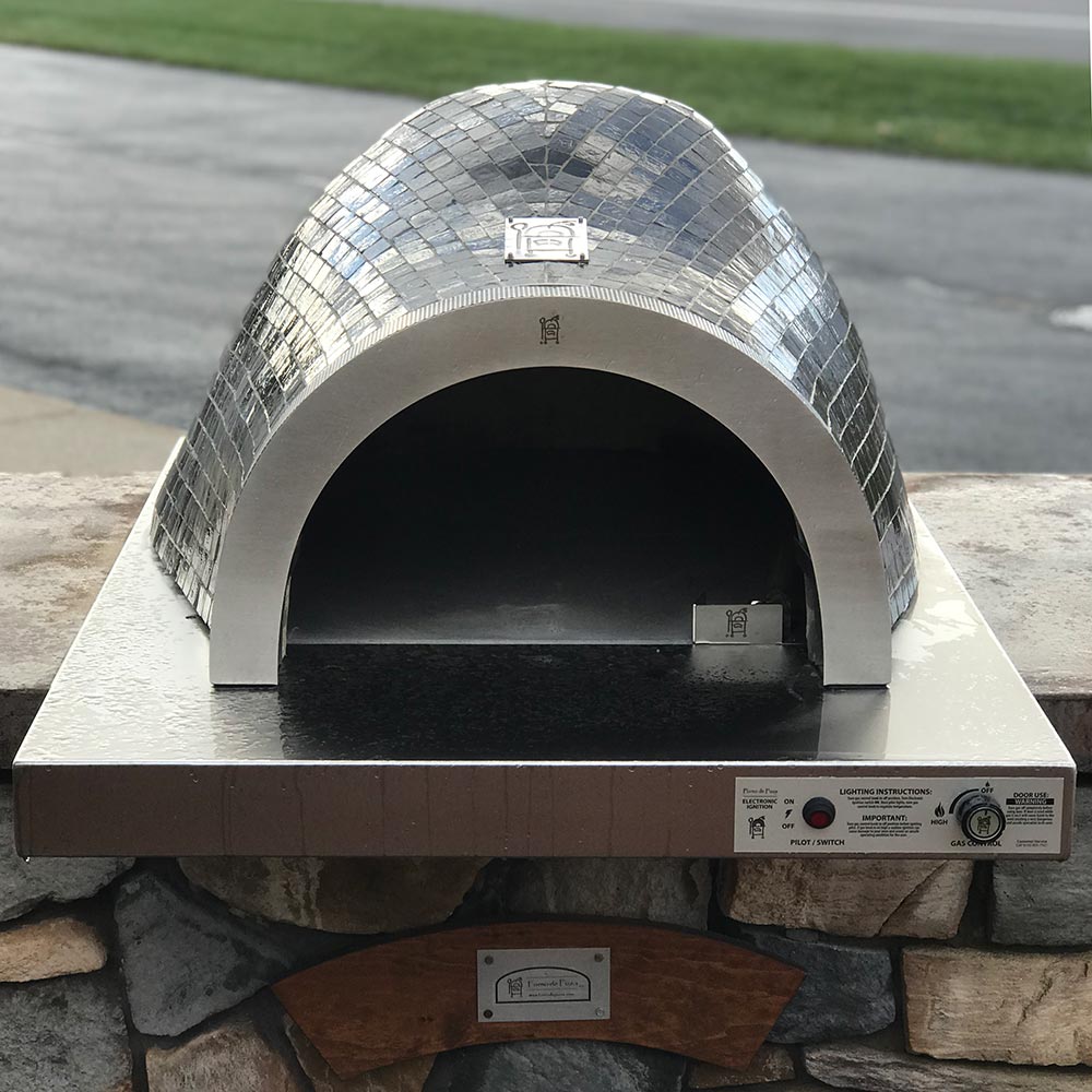 Glass tile pizza oven with arched opening and front control panel, silver mosaic dome