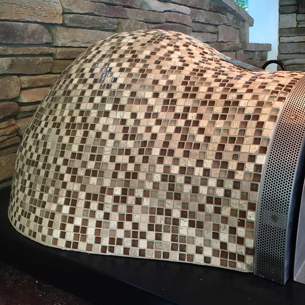 Glass tile pizza oven dome in multicolor mosaic with metal side vent panel