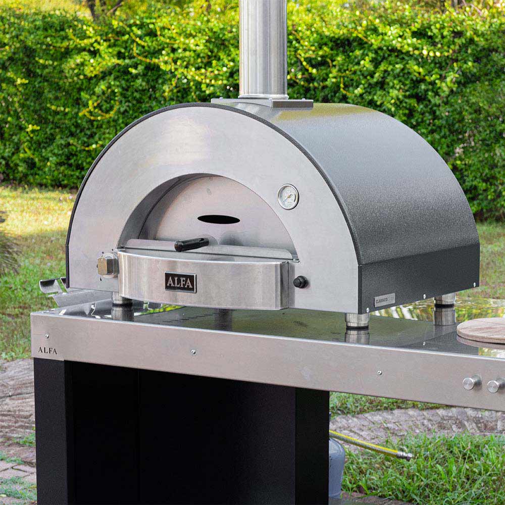 Stainless gas pizza oven with arched dome and countertop cooking station