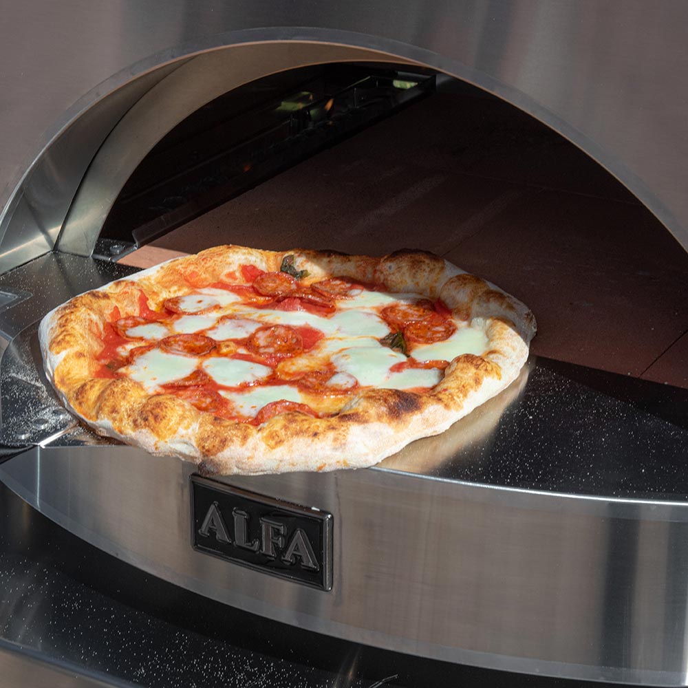 Pizza baking inside an Alfa countertop gas pizza oven with open domed mouth