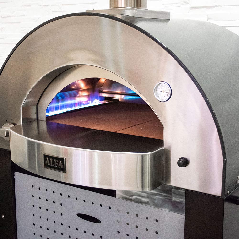 Gas pizza oven interior with arched stainless dome and burner flames visible through opening