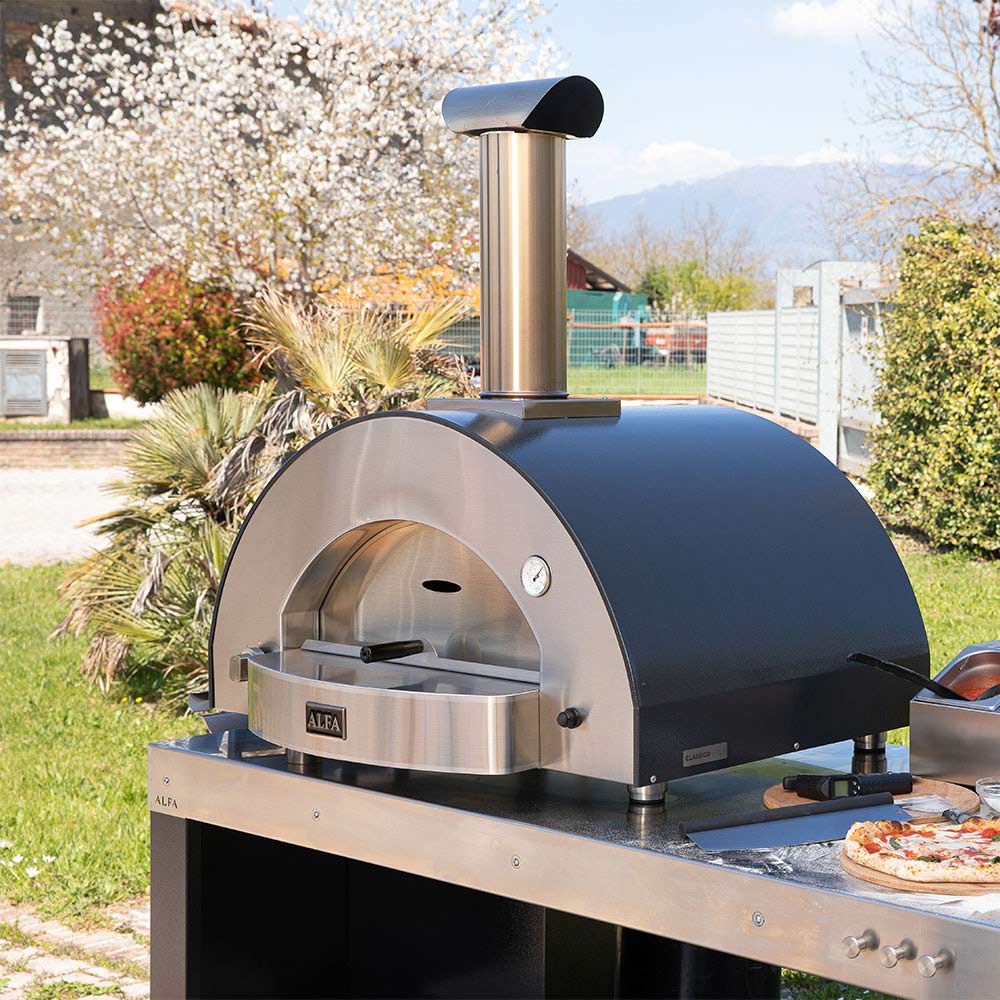 Alfa Classico 4 countertop gas pizza oven outdoors, stainless front and dark hood