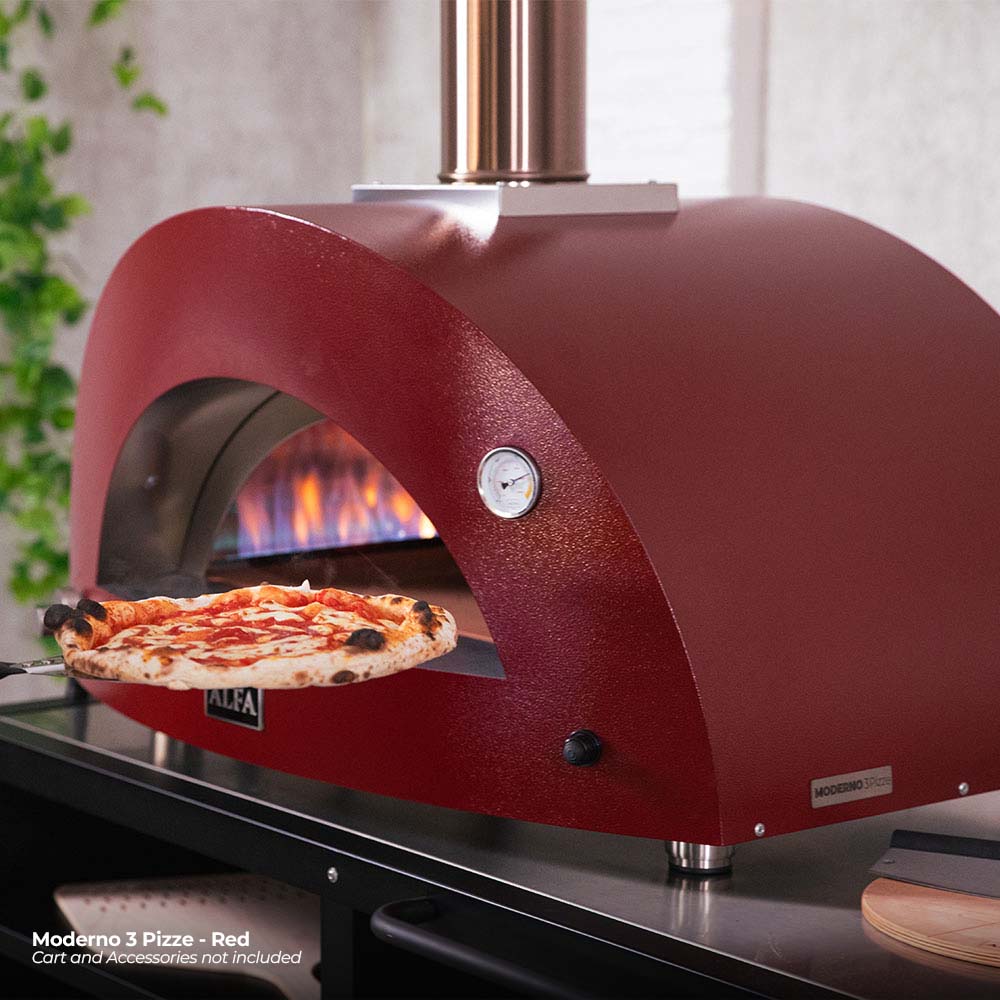 Ruby red gas pizza oven opening with a pizza being slid onto the stone