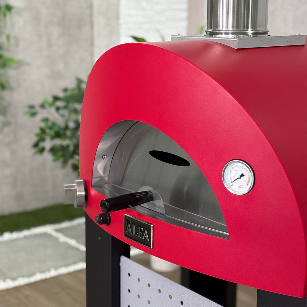 Red wood-fired pizza oven front with circular gauge and open chamber window