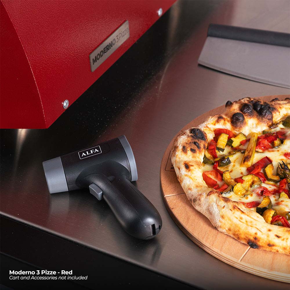 Close-up of antique red pizza oven with control area and pizza cooking inside