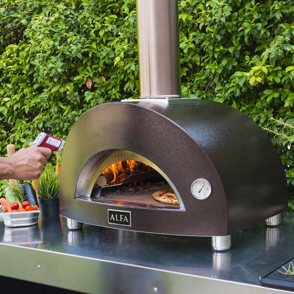 Wood-fired pizza oven with open arch and ALFA logo, flames visible during baking