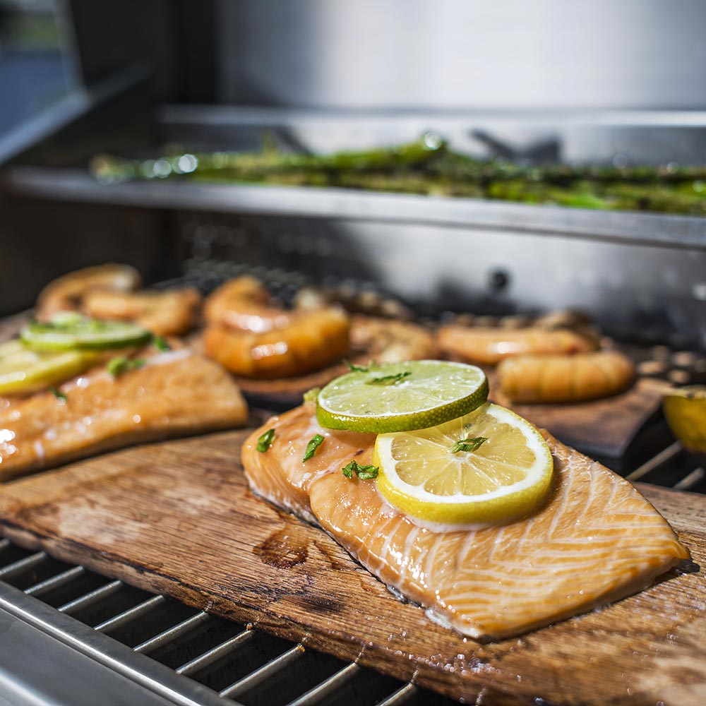 Infrared grill grates with salmon fillet and lemon slice cooking