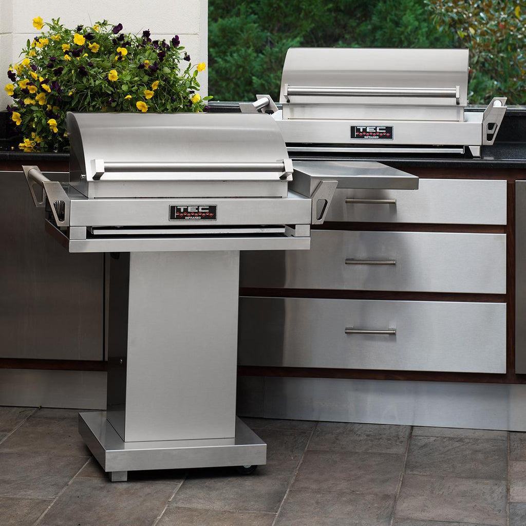 Portable grill on stand with side shelves and stainless steel finish
