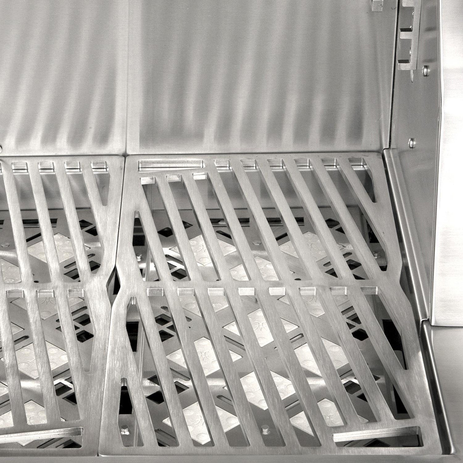 Stainless grill firebox with metal grates and open hood for cooking access