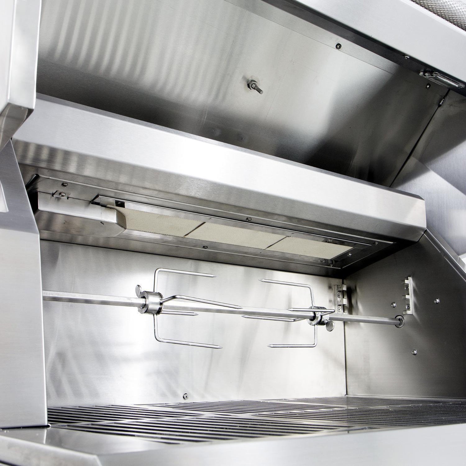 Open stainless gas grill interior with burners and warming rack