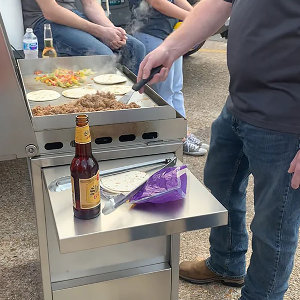 Freestanding griddle cart with open cooking surface and side shelf for prep items