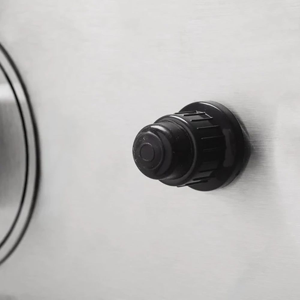 Black control knob on stainless gas griddle front panel