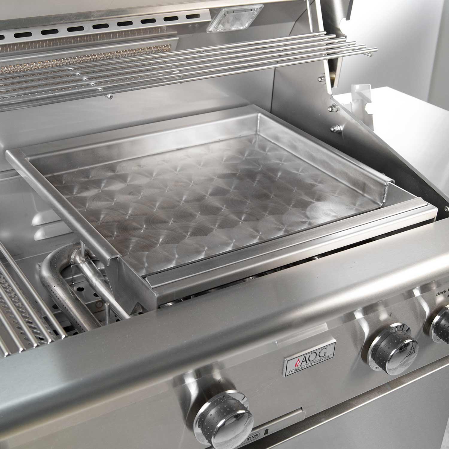 Stainless steel griddle insert with diamond-textured cooking surface in outdoor grill