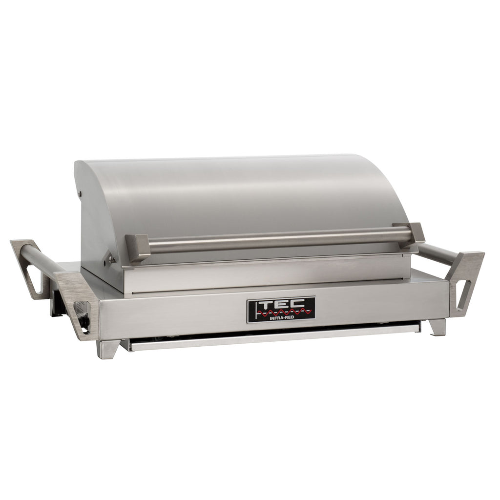 Portable tabletop grill with lid closed, stainless steel body and side carry handles
