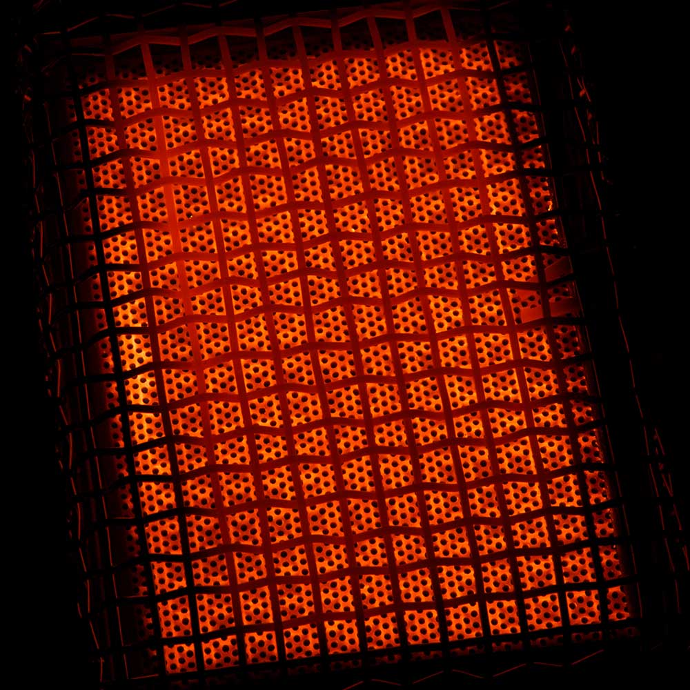 Infrared heating grid glowing orange inside the mini grill