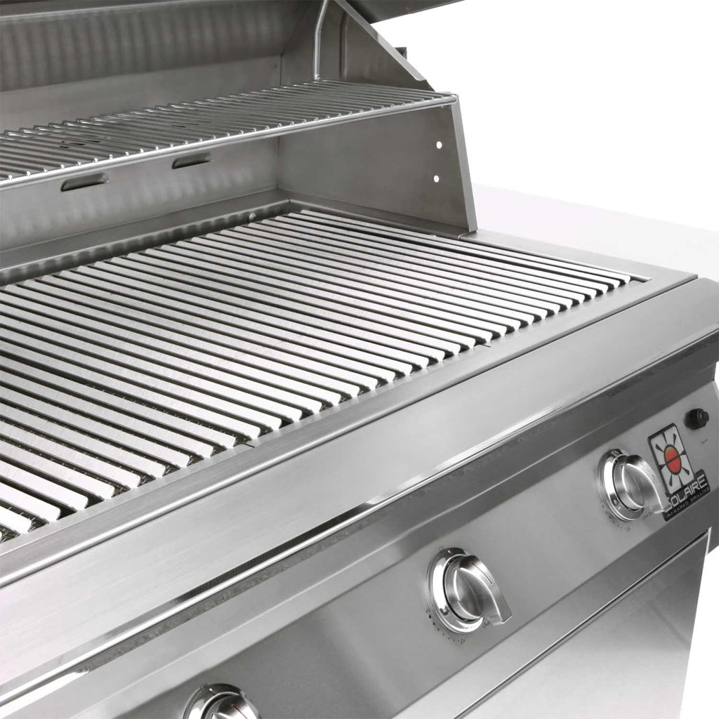 Stainless steel grill cooking grates with open hood panel and control knobs on front.