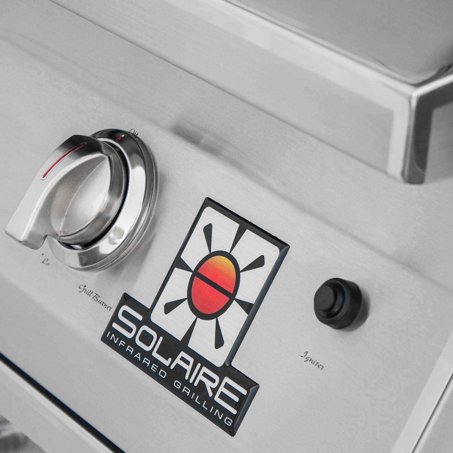 Grill control panel with chrome knobs and infrared/grill safety icons