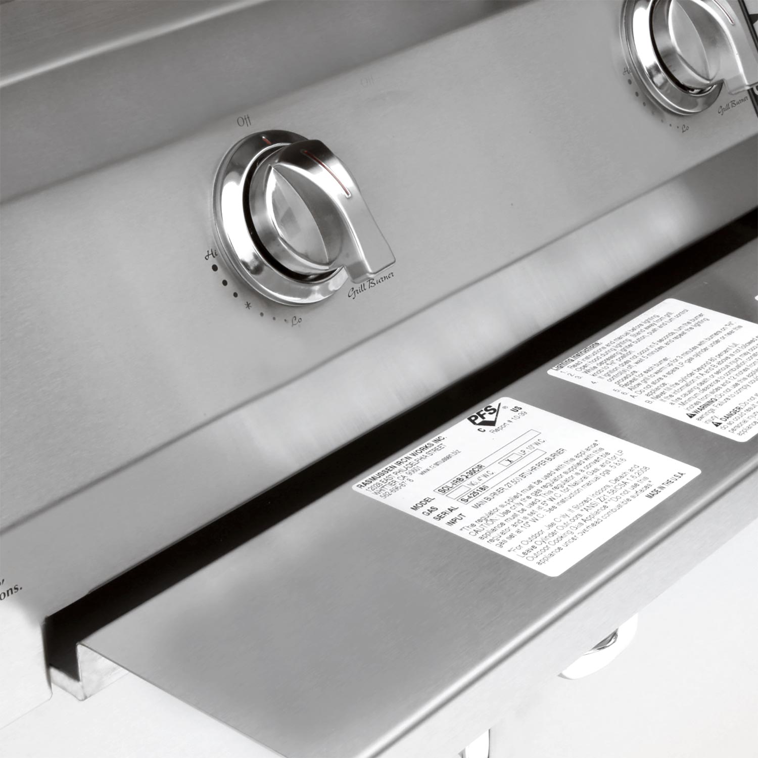 Stainless grill control knobs and burner markings on the front panel