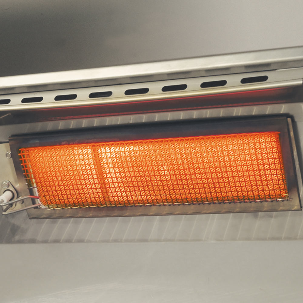 Infrared burner bar glowing orange inside the grill