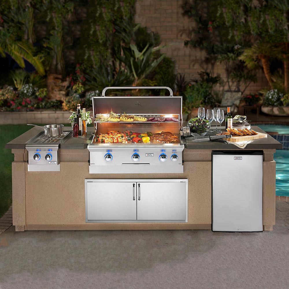 Built-in gas grill with side cabinet doors and open lid showing cooking area
