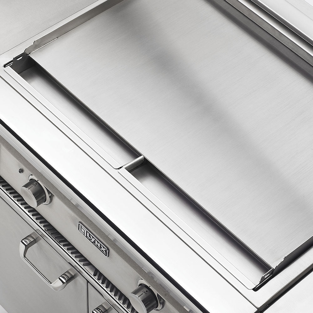 Stainless grill lid and main cooking area with burner controls visible