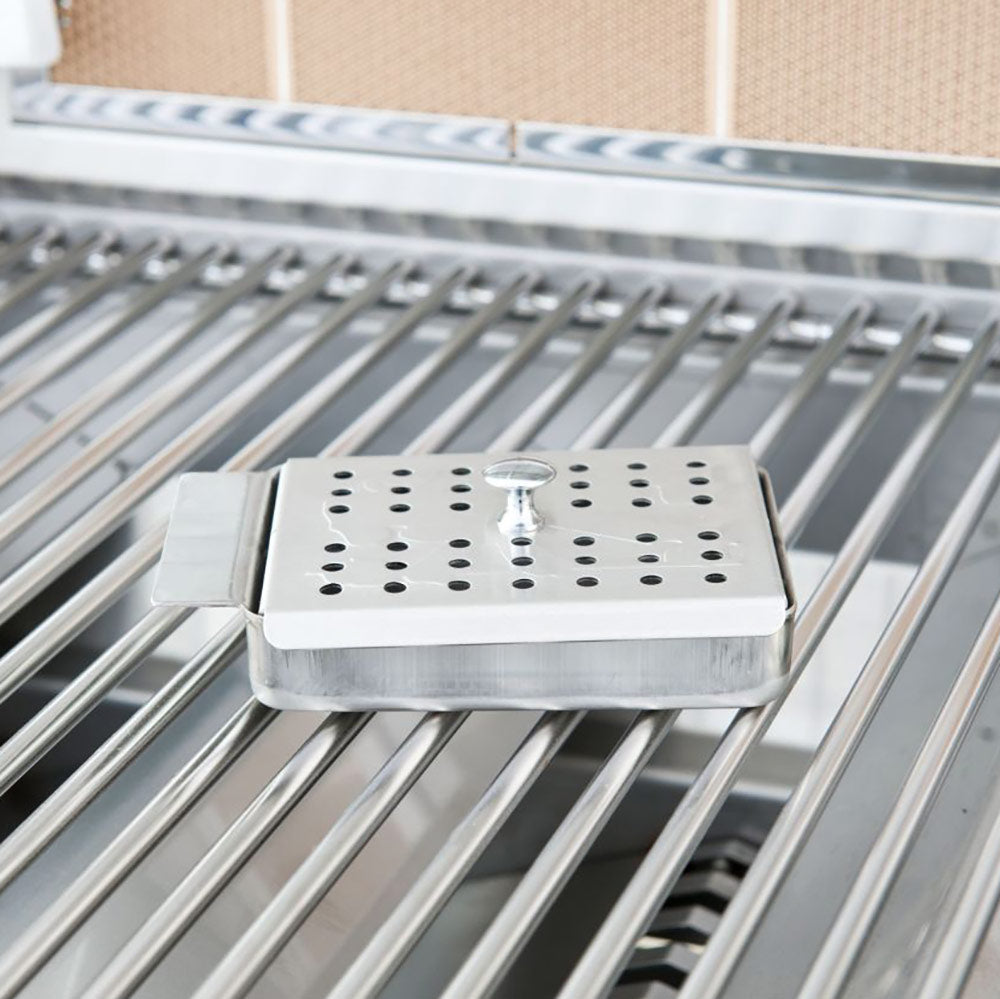 Perforated stainless steel smoker box on the grill cooking grates