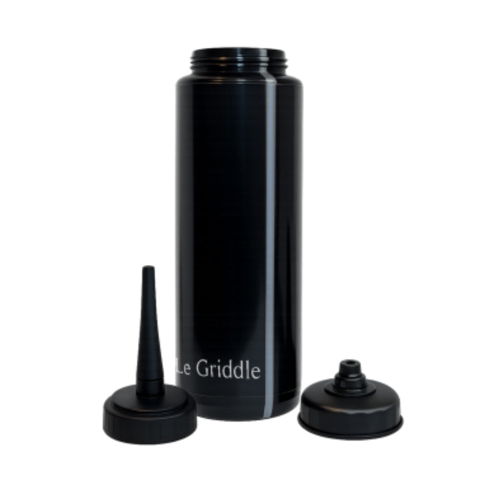 Black squeeze bottle with two interchangeable caps for precise oil dispensing