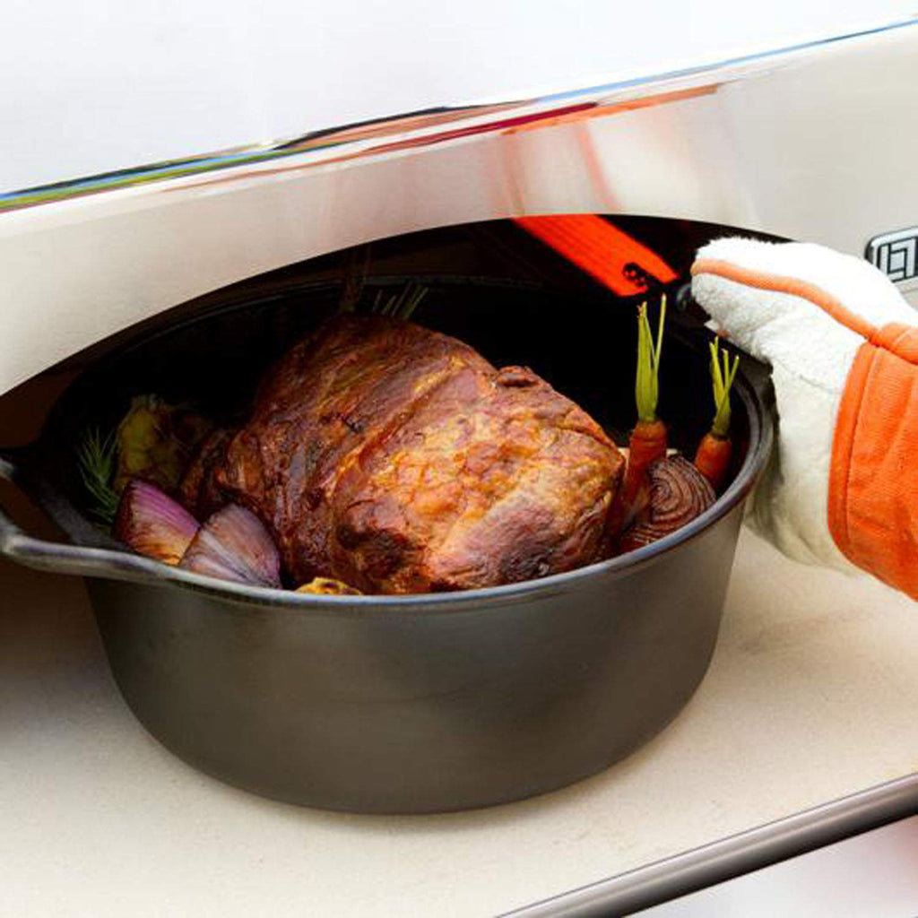Pizza oven with roasting tray inside, showing chicken and vegetables