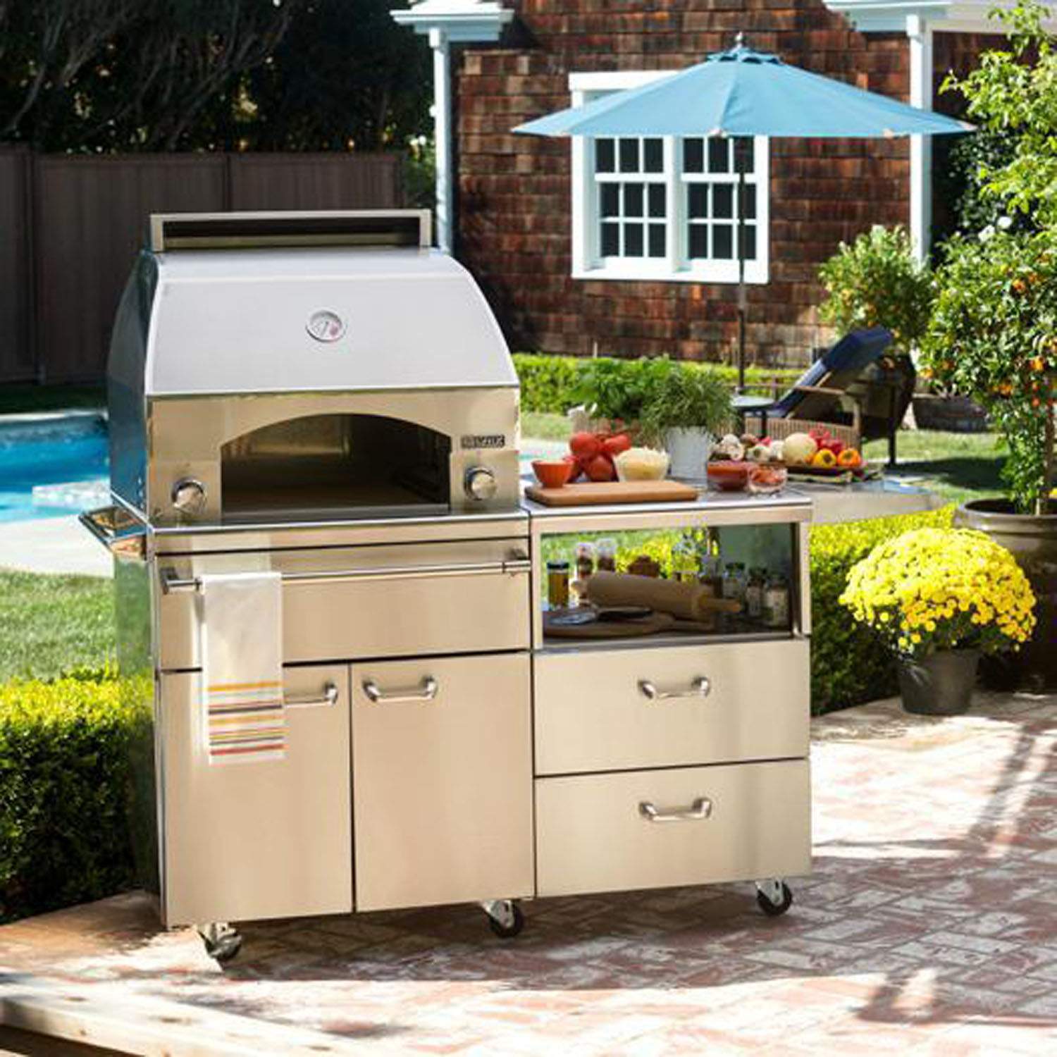 Pizza oven cart on wheels in patio setting, stainless body and countertop