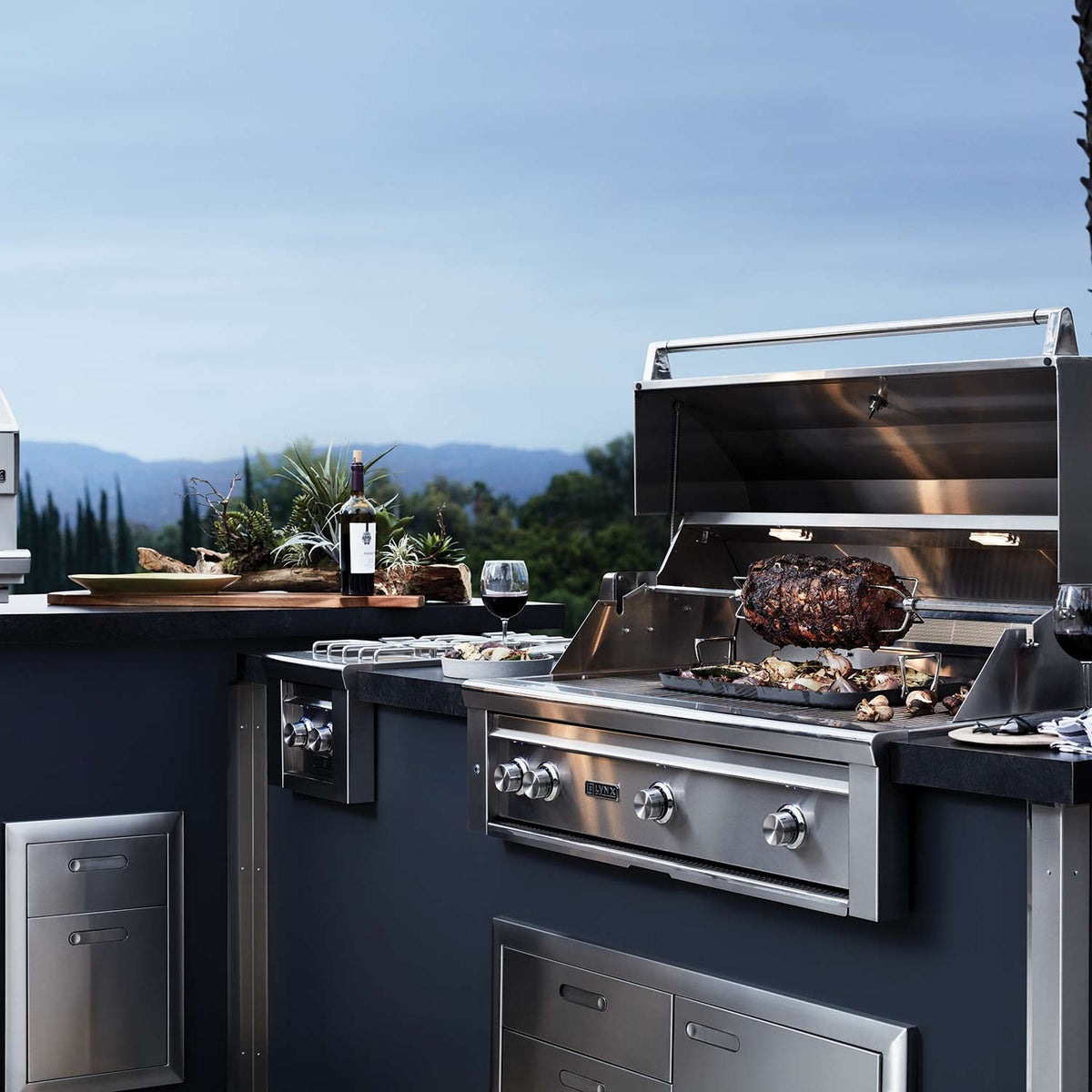 36-inch Lynx built-in gas grill with open lid and food on grates