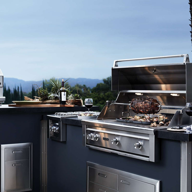 36-inch Lynx built-in gas grill with open lid and food on grates