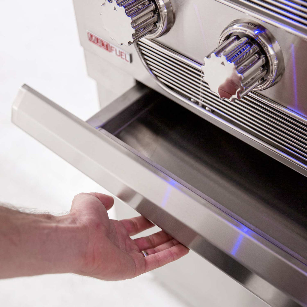 Dual fuel grill control panel with hand adjusting a front burner knob