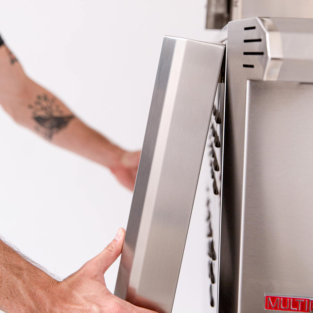 Stainless steel grill cabinet with man installing the side shelf board