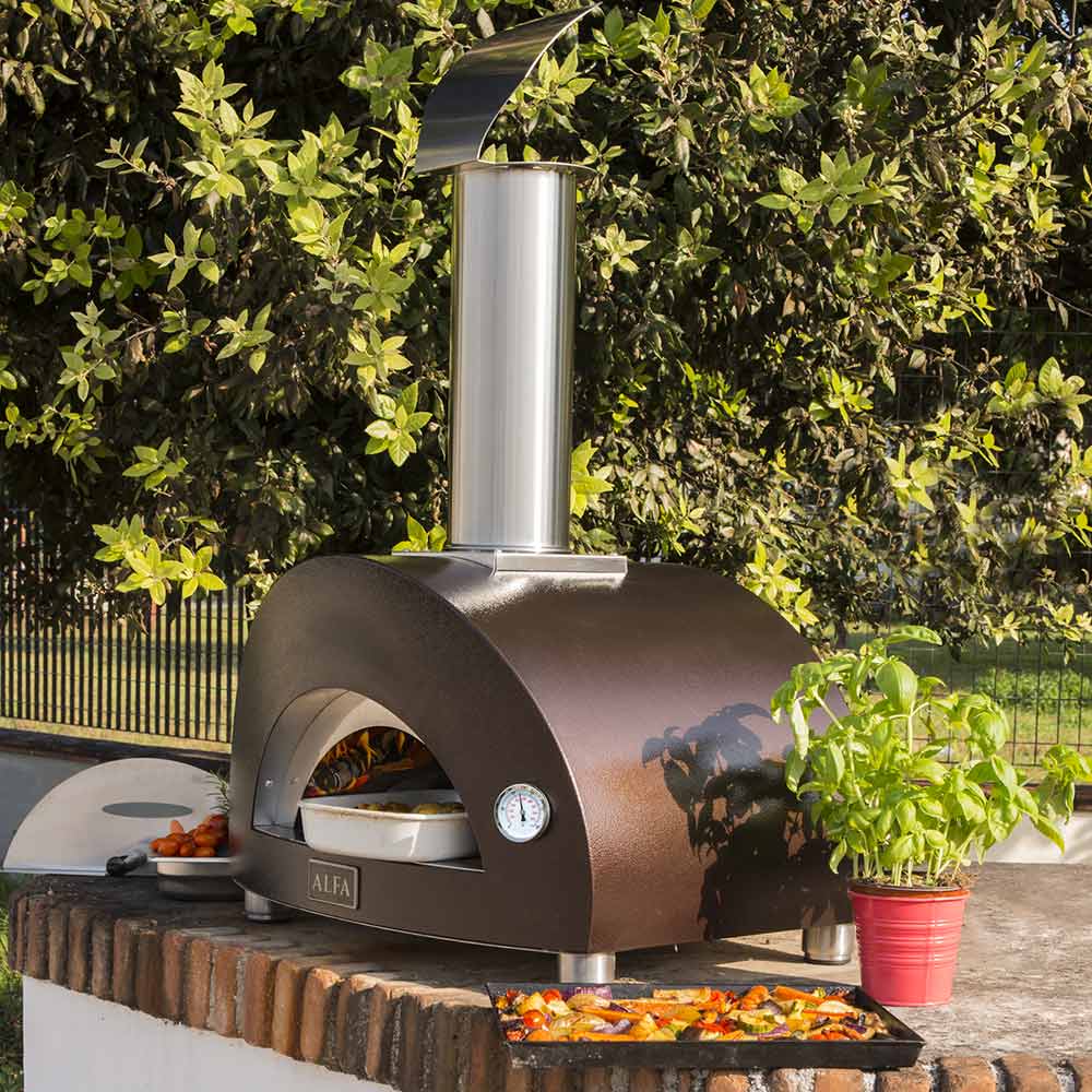 Alfa Nano outdoor wood-fired pizza oven with dark door and pizza baking on stone