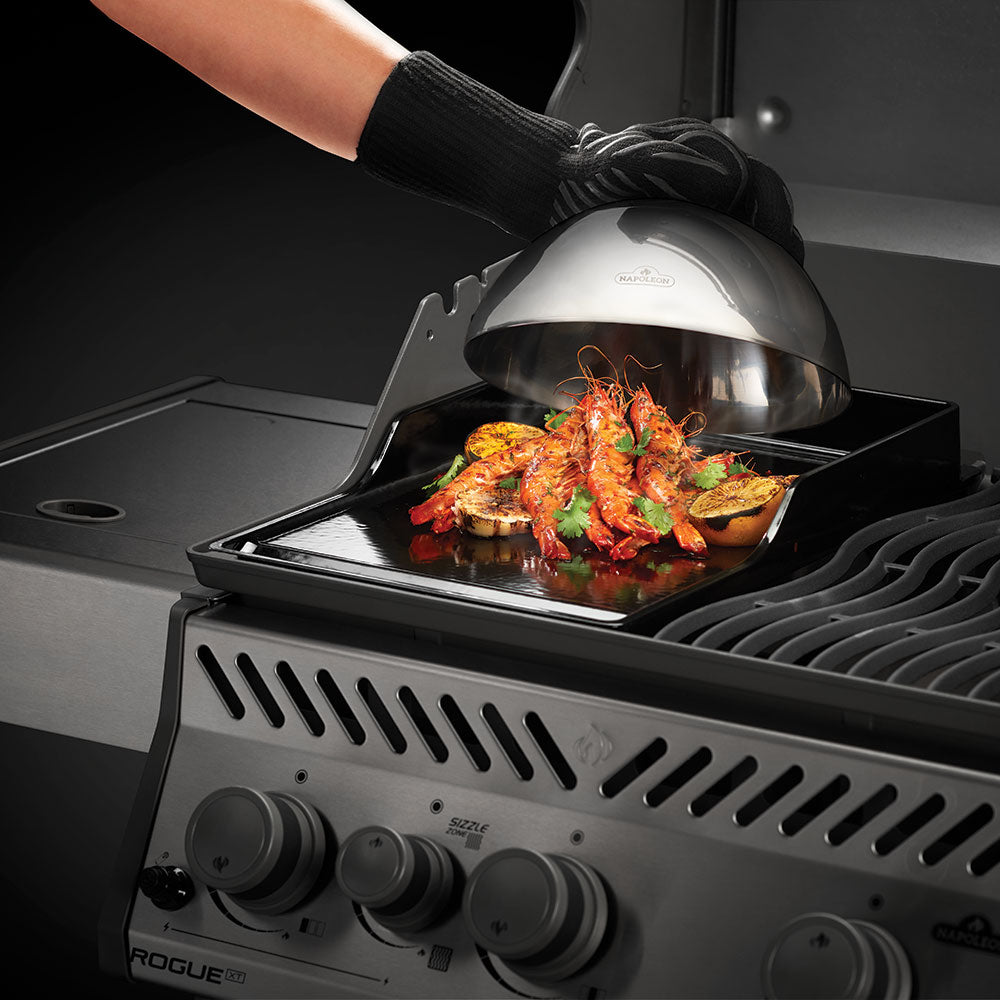 Stainless steel cooking dome lid over grilled food