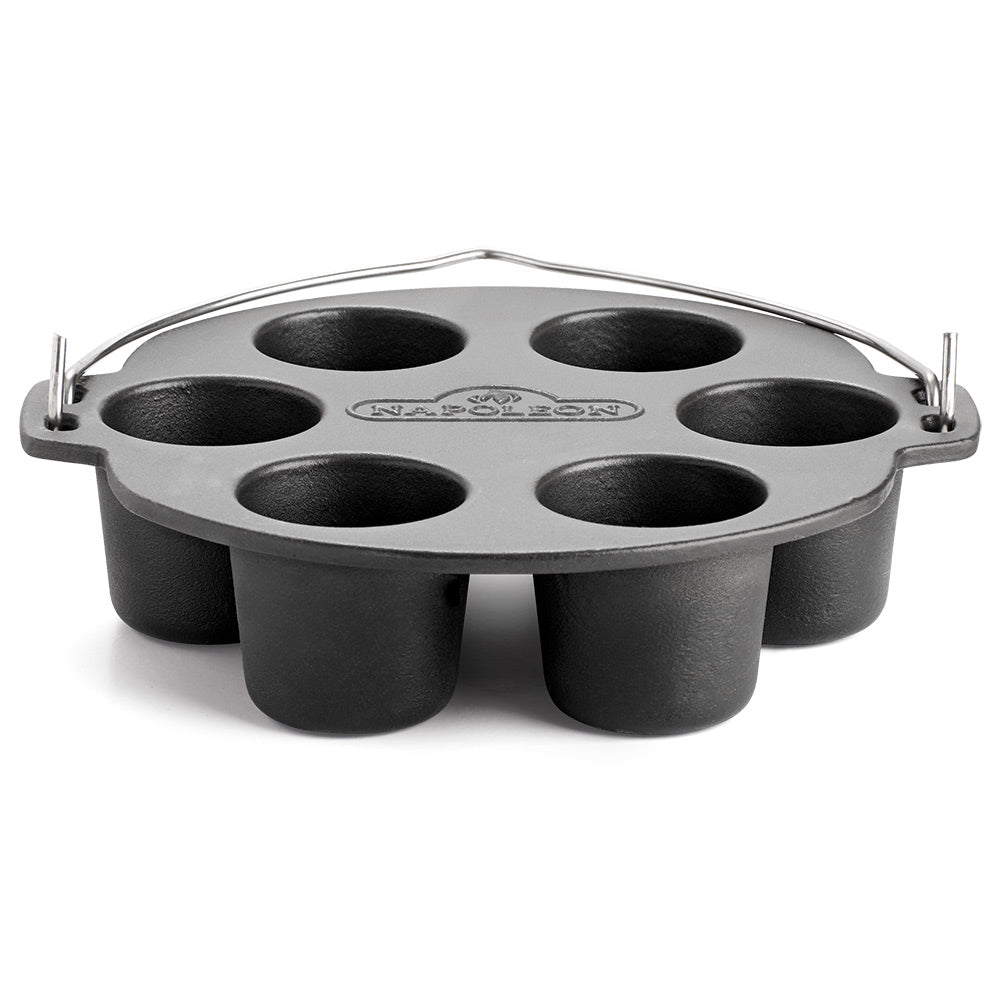 Cast iron muffin cooker with six round cups and arched handles, dark interior