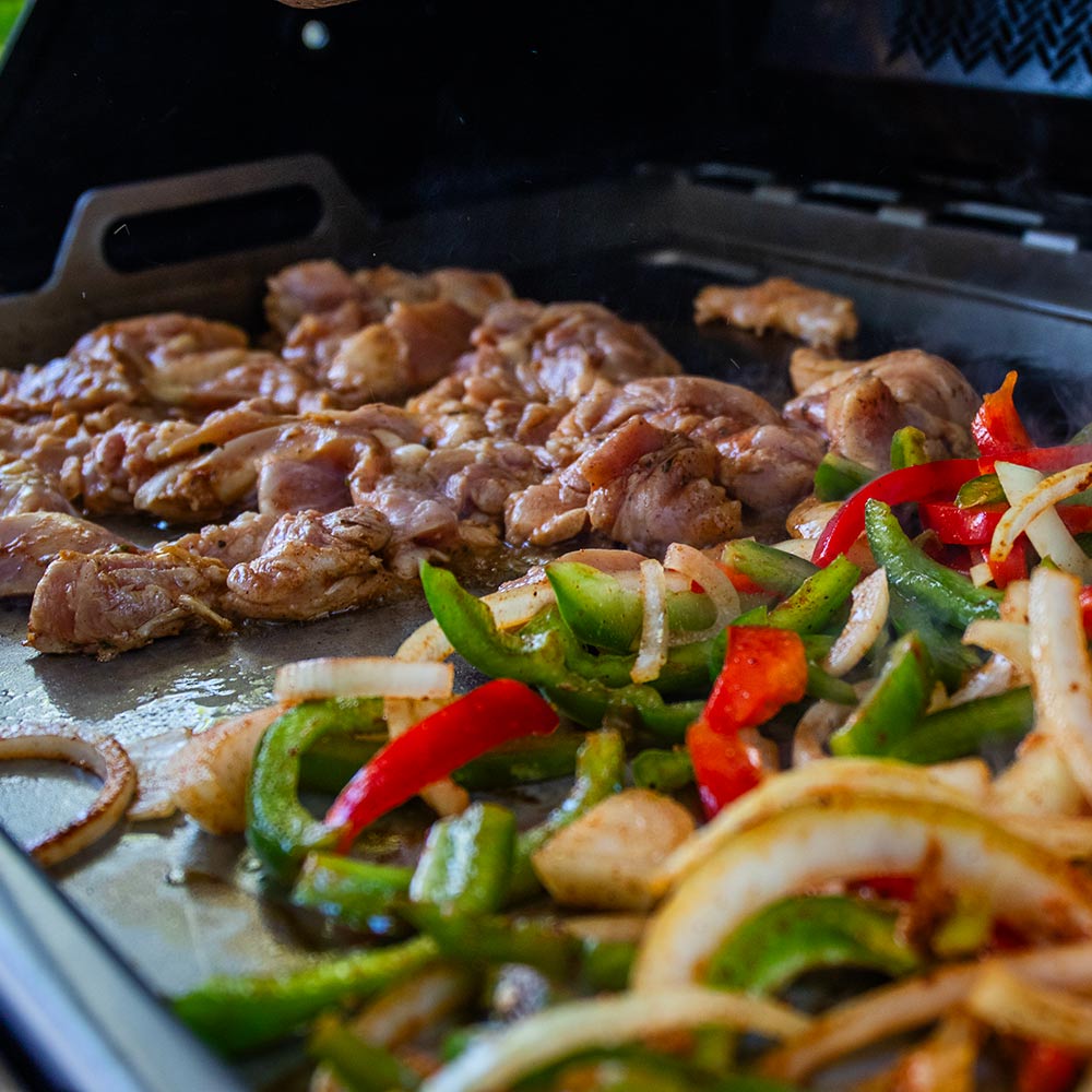 Griddle insert with grilled meat and peppers and onions