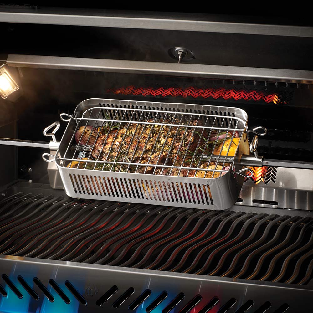 Stainless steel rotisserie basket holding cooked meat on the grill